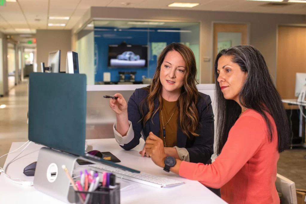 Two women sitting at an office desk